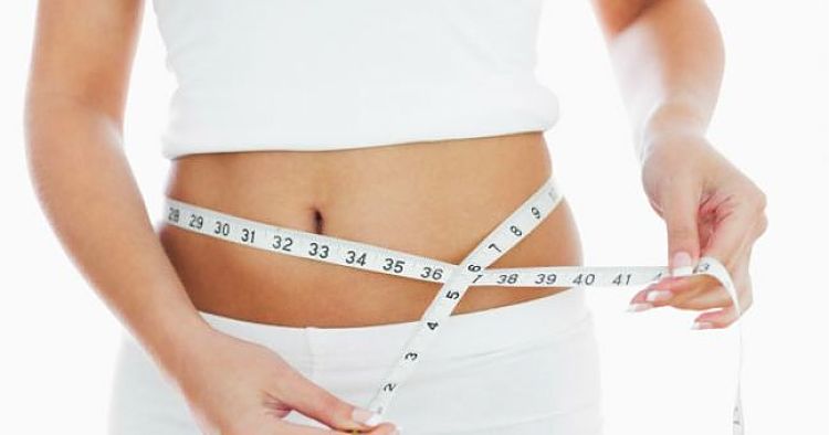 Woman using the string (tape measure) method for
  monitoring body mass and a ratio of waist diameter to body height ratio.  It is better than BMI index.